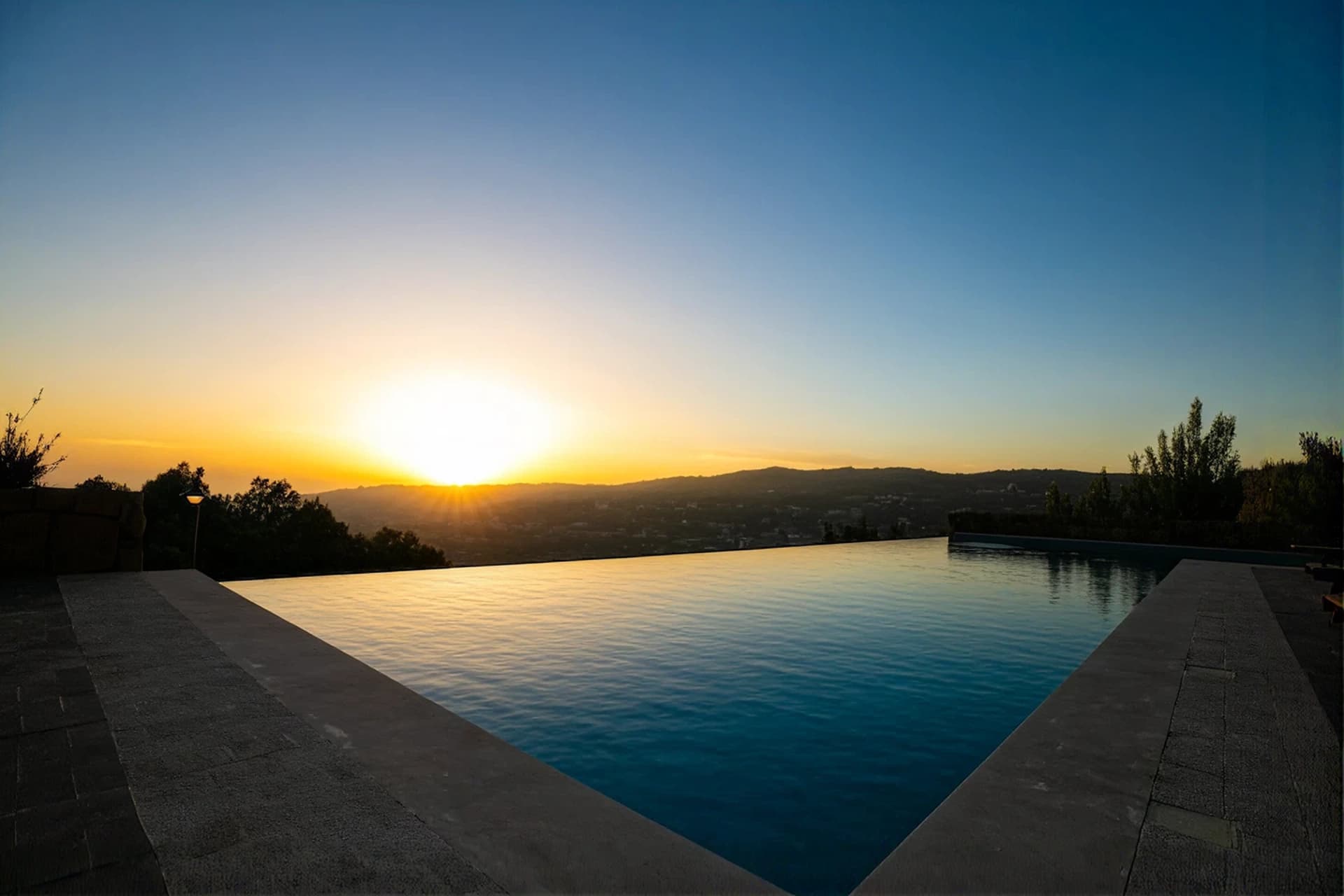 Sunset over the infinity pool at RedRock with the Faqra mountains beyond