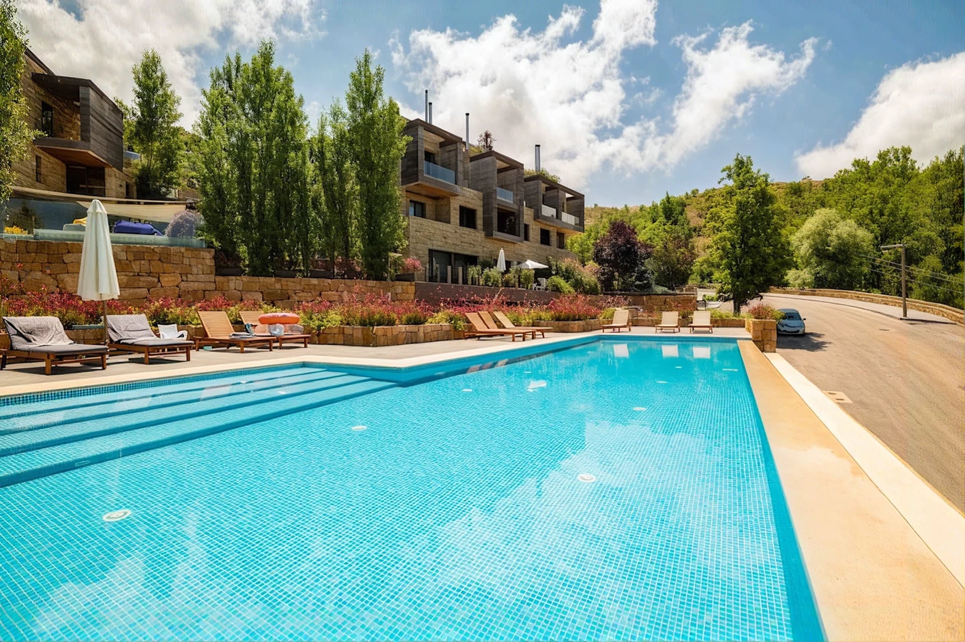The shared pool at RedRock with the stone chalets behind it