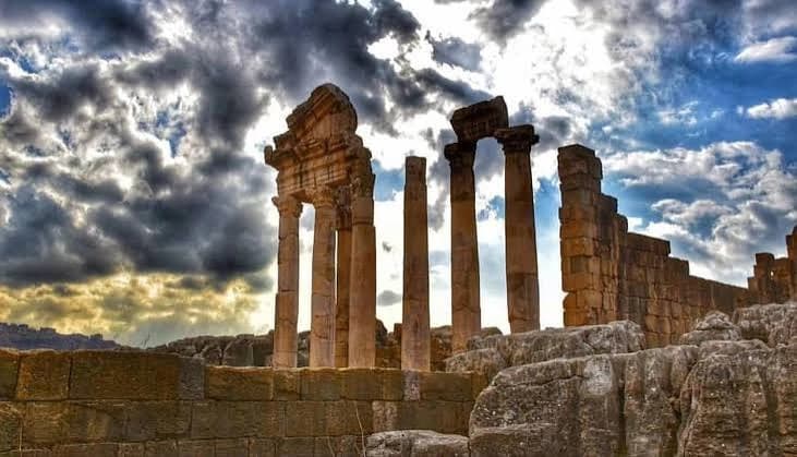 Columns and the gateway of the Roman temple at Faqra under a stormy sky